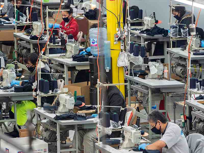 Several workers in the garment industry sew masks to meet the coronavirus demand.