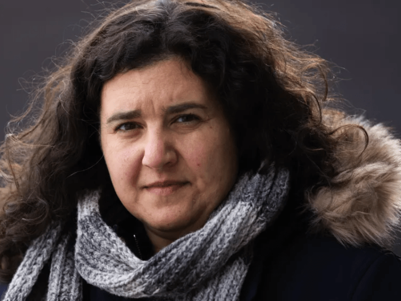 Liza Rankin looks into the camera, wearing a concerned expression